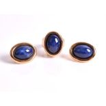 An 18ct yellow gold and imitation star sapphire demi-parure comprising: a ring and a pair of