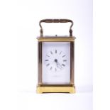 A French petite sonnerie gilt brass carriage clock the central enamel dial with Roman numerals,