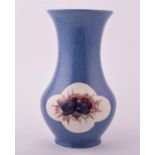 A William Moorcroft powder blue vase of tapering baluster form with flared neck, with symmetrical
