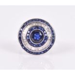 A sapphire and diamond cocktail ring of target design, centred with a round mixed-cut sapphire,