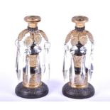 A pair of 19th century ormolu and bronze table lustre candlesticks with suspended cut glass prism