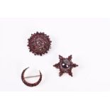 Three bohemian garnet brooches one star-shaped, one of circular cluster form, the other crescent-