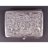 An Eastern white metal cigarette case the top deeply carved and engraved with pilgrim scenes of