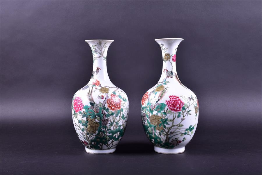 A pair of 19th century Chinese porcelain vases the ovoid shaped bodies decorated with enamelled