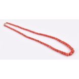 A graduated naturalistic coral bead necklace with 18 ct gold clasp, 62 cm long, largest bead 12 x 12