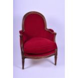 A French carved beechwood red covered armchair designed with studded red velvet upholstry, raised on