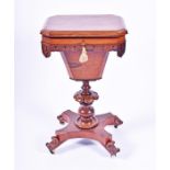 A Victorian rosewood work table opening to reveal a velvet and leather lined interior with fitted