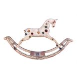 A large late 19th century Victorian rocking horse painted pine wood with an unusual cream ground