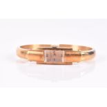 A Baume Mercier ladies 18ct gold bangle wristwatch the rectangular gilt dial with Roman numerals, in