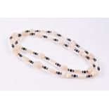 A mother-of-pearl, onyx, and crystal beaded necklace opera length.