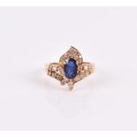 An 18ct yellow gold, diamond, and sapphire ring set with a mixed oval-cut sapphire, within a