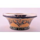 A William Moorcroft Macintyre bowl of flared form decorated with symmetrical foliate motifs, 23 x 11