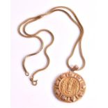 A 10ct gold medallion pendant depicting three saints within a stylised and textured border, on an
