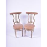 A pair of Louis XVI French lyre back chairs with studded velvet upholstery, supported on four