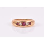 An 18ct yellow gold, diamond, and ruby ring inset with three rubies and two diamonds, size M 1/2,