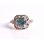 An Art Deco style zircon and diamond ring centred with a round mixed-cut blue zircon weighing