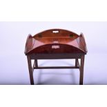 An early 20th century mahogany butler's table with hinged pierced side, on a later stained oak base,
