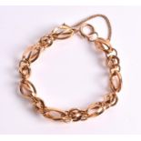 A 14ct yellow gold bracelet composed of fancy oval and circular open-worked links, with safety