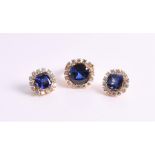 A synthetic sapphire and diamond demi-parure comprising: a ring and a pair of earrings, each centred
