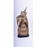 A 20th century gilded and painted Eastern temple figure with elaborately carved and decorated robes,