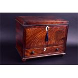 A late Georgian period mahogany workbox with ivory escutcheons, the lifting top to reveal a fitted