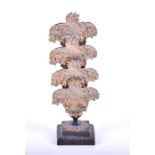 A Victorian brass letter rack with three slots, embossed decoration of flowers and leaves, with