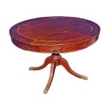 A Chinese hardwood dining table and four chairs the circular table with a carved frieze over a