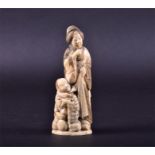 An early 20th century Japanese carved ivory Okimono c.1920, formed as a standing woman, with a