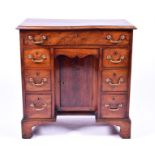 A good quality Georgian mahogany knee hole pedestal desk of small proportions  the central well