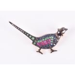 A silver gilt and gemstone brooch in the form of a pheasant  set with emeralds, rubies, and