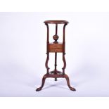 A Victorian walnut small plant stand supported on a tripod stand with two central drawers and a