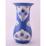 A large William Moorcroft powder blue vase of footed baluster form with cylindrical rim, decorated