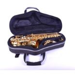 A brass Sakkusu saxophone in a fitted carry case.