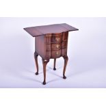 A Queen Anne style three draw walnut bedside table with a pair of folding flaps, the drawers with