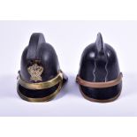 A set of two leather and brass mounted fireman helmets by James Hendry comprising one Manchester