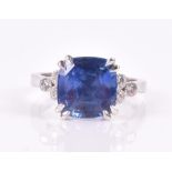 An 18ct white gold, diamond, and sapphire ring set with a cushion-cut natural Sri Lankan sapphire of