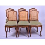 A set of six Louis XV carved walnut chairs with woven caned backings and seats, carved with rococo