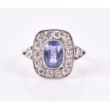 An 18ct white gold, diamond, and sapphire cluster ring set with a rectangular cushion-cut sapphire