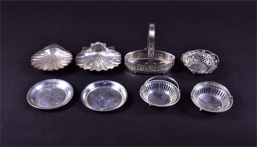 A mixed group of 19th century and later silver dishes and baskets to include two shell formed