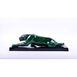 A French art deco style ceramic panther glazed in a bottle green colour, realistically rendered in a