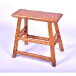 A Chinese stained elm pegged stool with four swept supports, united by pegged stretchers, 54 x 55