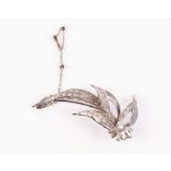 A white metal and diamond spray brooch set with baguette and round cut diamonds, largest