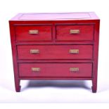 A small 20th century Chinese lacquered chest with two short over two long drawers, on shaped feet,