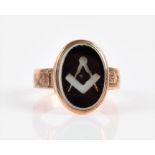 A yellow gold and agate Masonic ring set with an oval agate doublet engraved with a Masonic square
