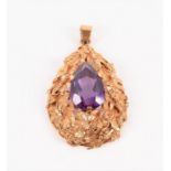 A yellow metal and synthetic corundum pendant of pear-shaped form, set with a gemstone within an