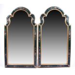 A pair of decorative painted wall mirrors decorated in the barge-ware style of shaped arched form,