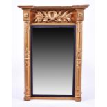 A 19th century gilded pier mirror the top moulded with leaves, column sides and ebonised bezel,