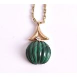 A carved malachite pendant highlighted above with a round brilliant-cut diamond, in unmarked gilt