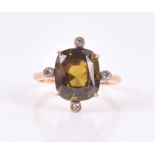 An 18ct yellow gold and green gemstone ring likely tourmaline or olivine, the cushion-cut stone