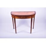 An Edwardian Sheraton revival satinwood demi lune card table the cross banded top opening to